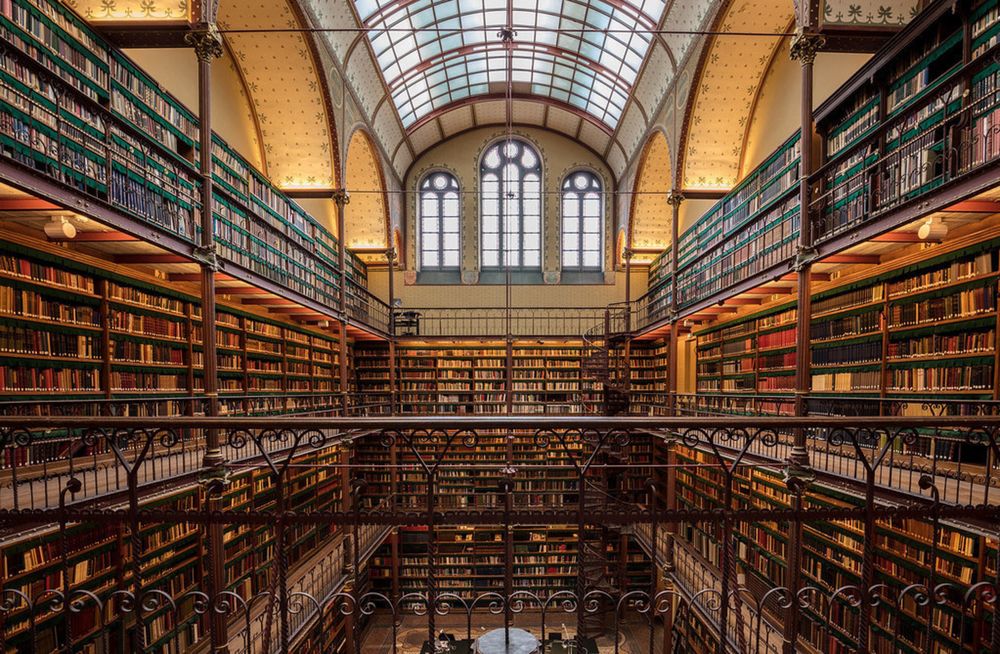 A four-story old library with thousands of books and a glass ceiling.