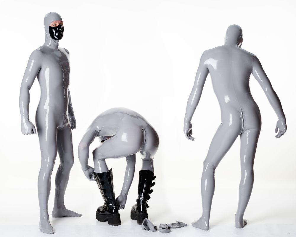 Suited up in a grey, face-entry latex catsuit.