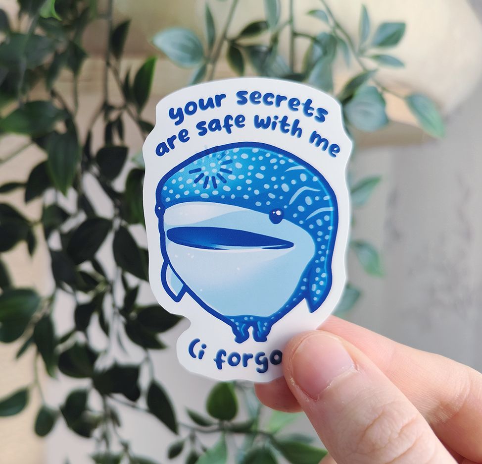 Hand holding up a sticker of a whale shark standing and thinking, titled "your secrets are safe with me (i fogrot)"