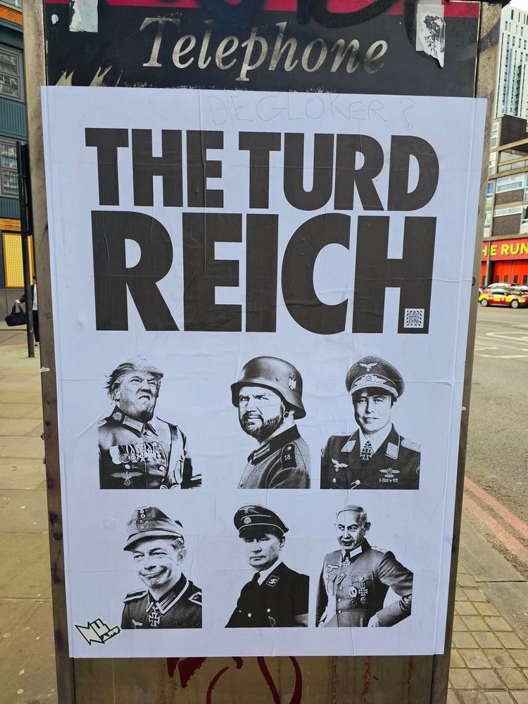 Sign with trump cabinet dressed as nazi's caption "The Turd Reich"