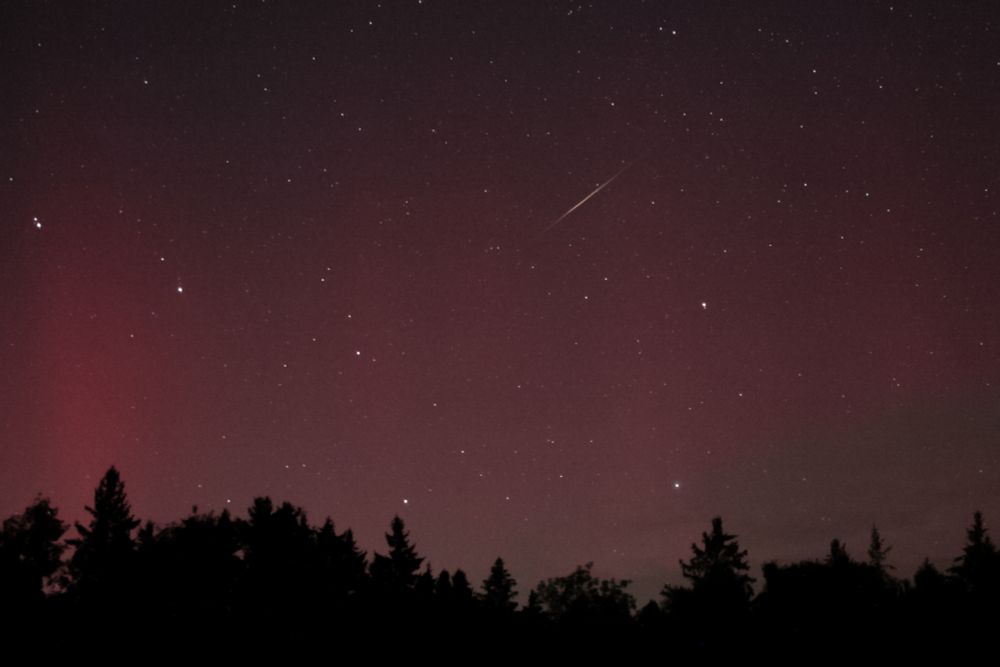 Meteor passing through the aurora
