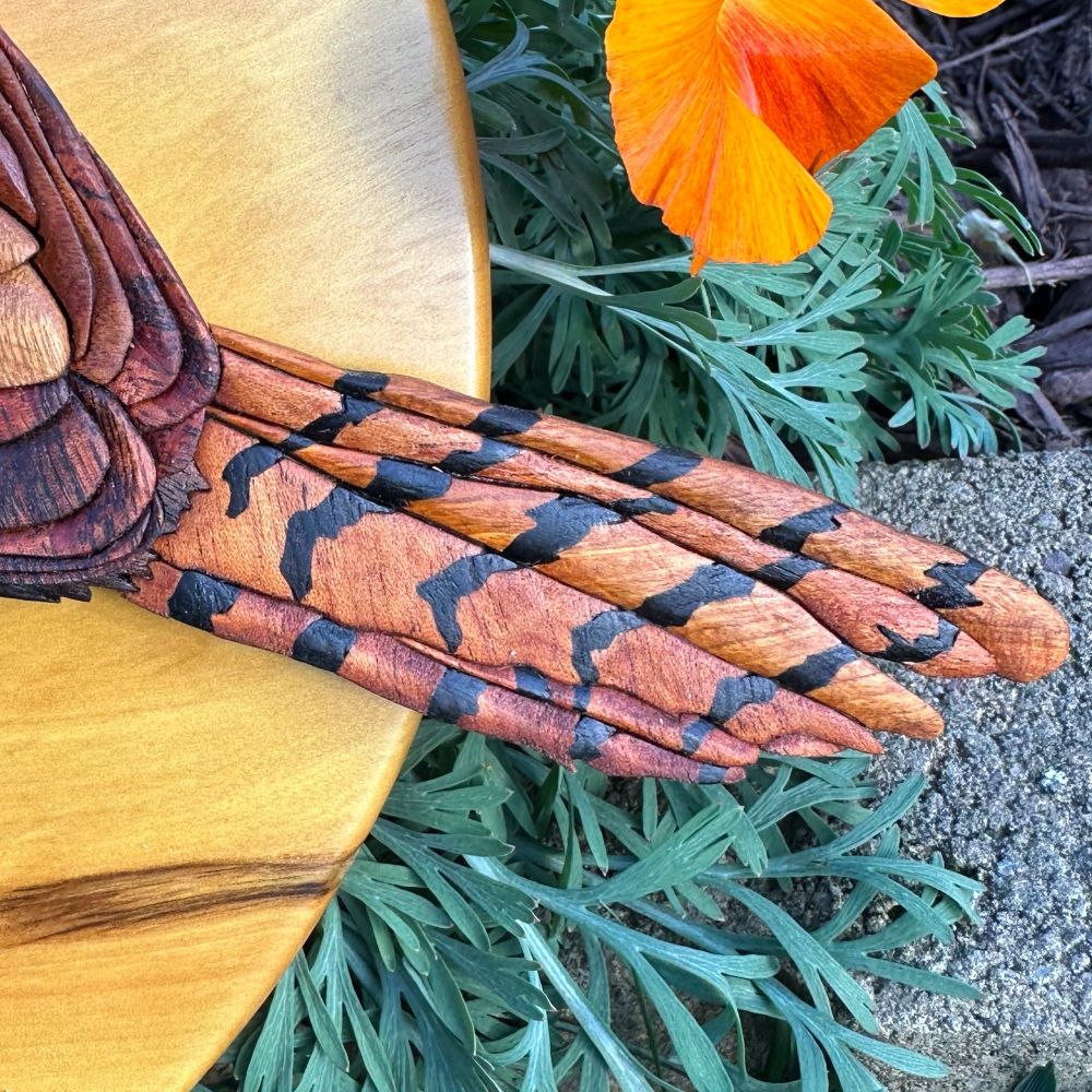 A “wooden intarsia” artwork of a canyon wren made from 13 species of wood. Closeup 