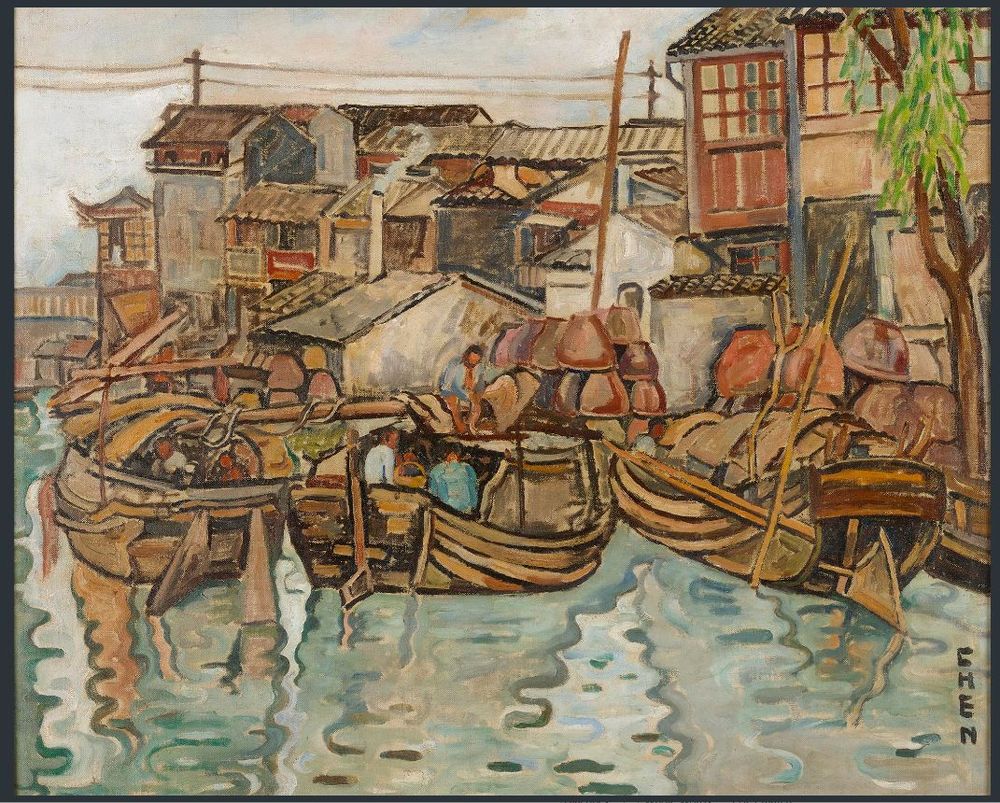 Foreground: water; centre: wooden boats at the quayside, laden with goods; background: houses; far right, a single tree