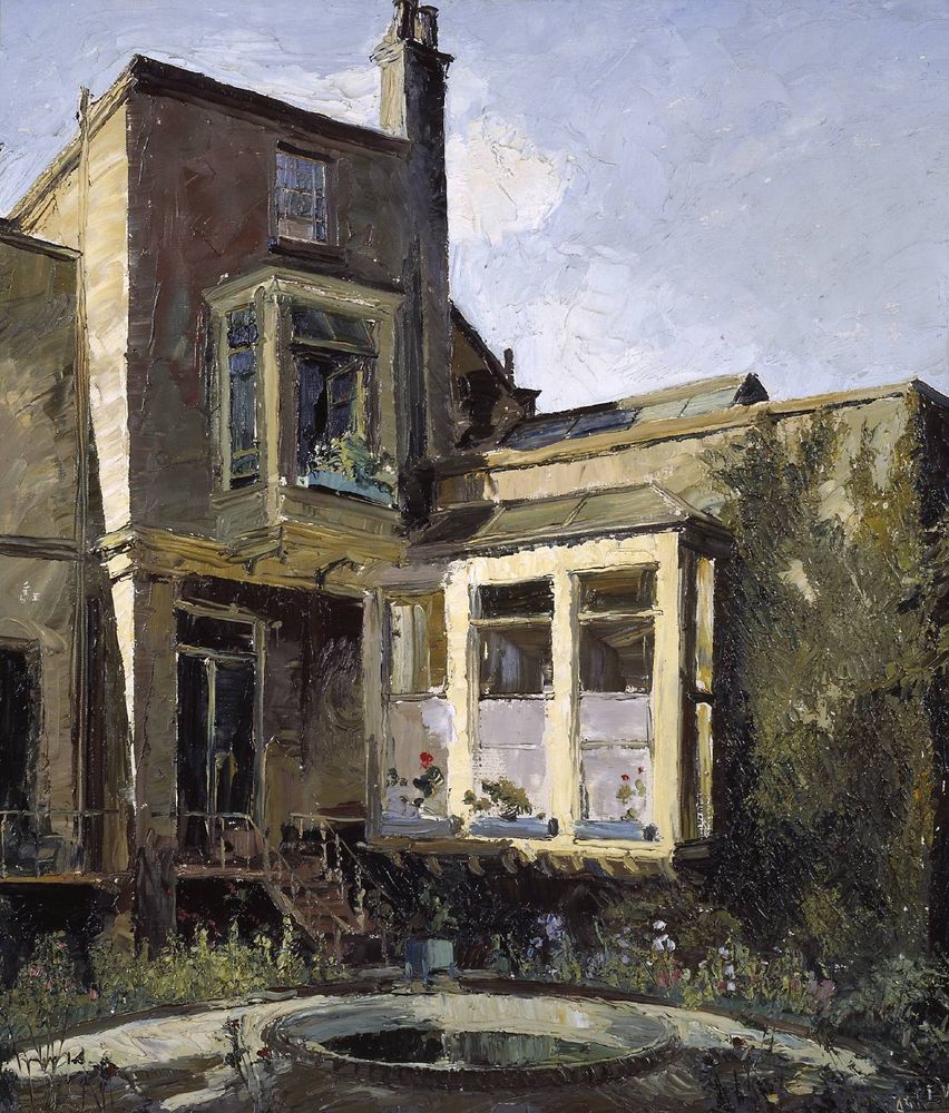 Back of a house. On the ground floor a room at right angles to the main house. The window of that room catches the sunlight. The main house has a bay window on the first floor and a small window on the floor above that. The ground floor appears to have a double glass door that leads via a few steps to the garden which has a small circular pond and flowers in the border.