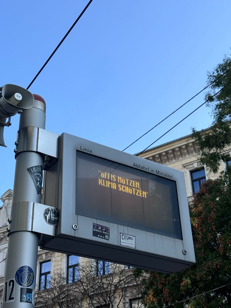 Anzeigebildschirm der Straßenbahn mit „Öffis nützen Klima schützen“