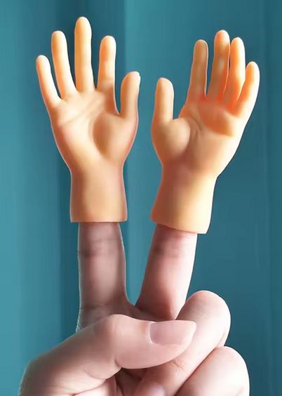 Two miniature plastic hands that attach to the tips of your fingers, shown on a hand making a peace-sign.  One is attached to the index finger and one to the middle fingers.