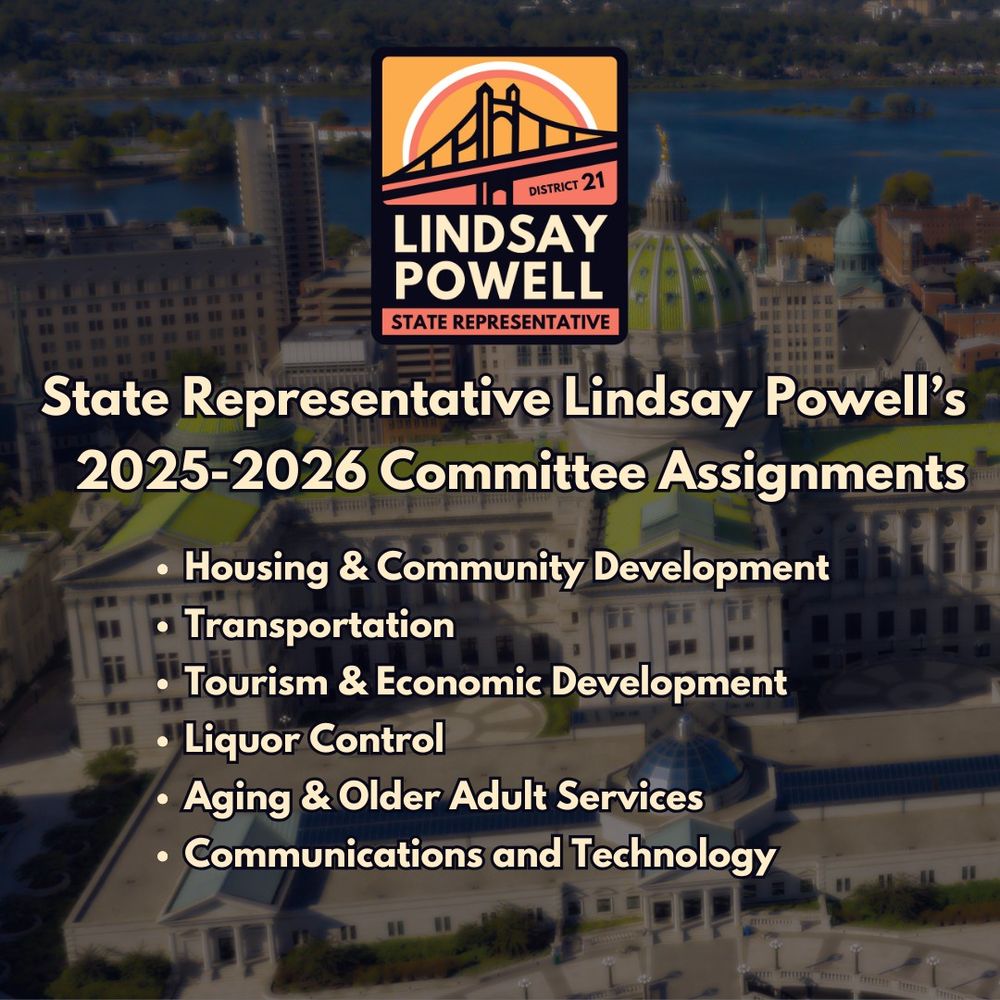 Graphic featuring a background of the Pennsylvania State Capitol building in Harrisburg with a view of the city and river. The text reads: "State Representative Lindsay Powell's 2025-2026 Committee Assignments" with the following committees listed: Housing & Community Development, Transportation, Tourism & Economic Development, Liquor Control, Aging & Older Adult Services, and Communications and Technology. At the top is the logo for Lindsay Powell, State Representative, District 21, which includes a stylized bridge and sun.
