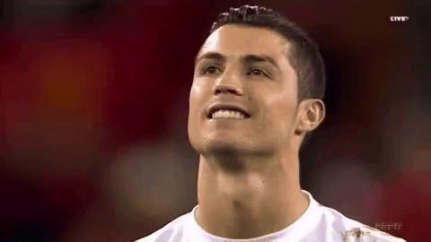 a close up of a man 's face with a red background and a smile on his face .