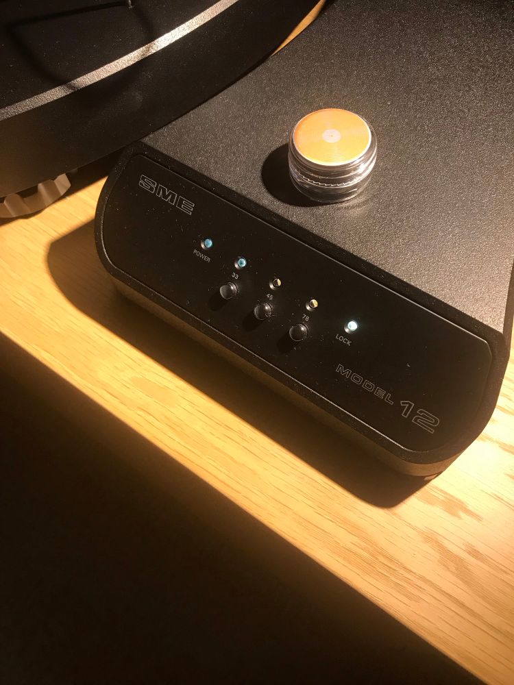 Gel stylus cleaner on a turntable power supply.