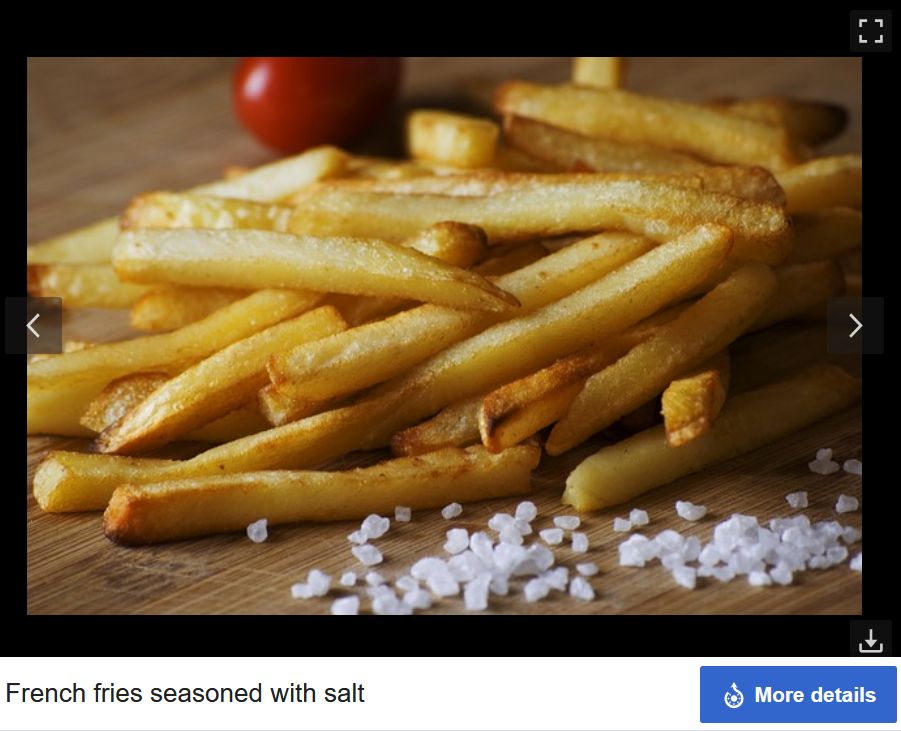 the wikipedia image of french fries seasoned with salt, where the salt isnt on the fries, is way too coarse, and theres a tiny tomato in the background for some reason. bizarre image.