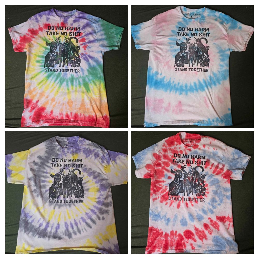 4 block print shirts, a rainbow, trans, Non-binary, and red / white/ blue all with the same design, a group of animals (deer fox wolf cougar raccoon) standing together with text above and below them, above reads 'do no harm take no shit' and below reads 'stand together'