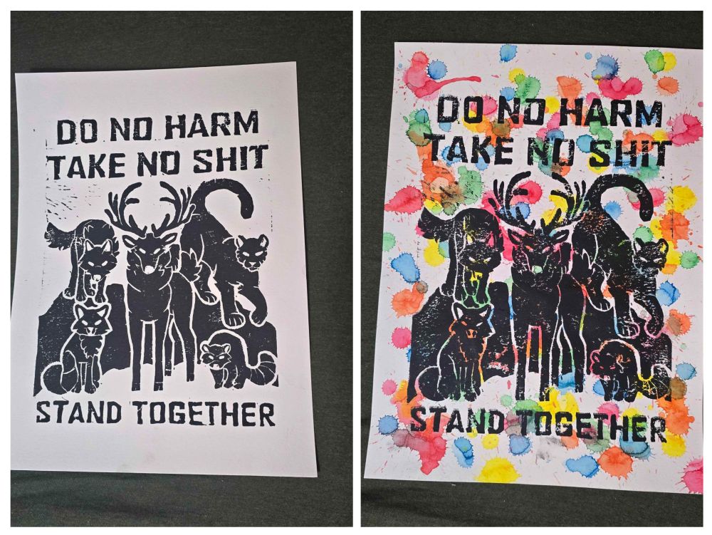 two paper prints of a group of animals (deer fox wolf cougar raccoon) standing together with text above and below them, above reads 'do no harm take no shit' and below reads 'stand together' one on white paper, the other on a rainbow splatter watercolor background