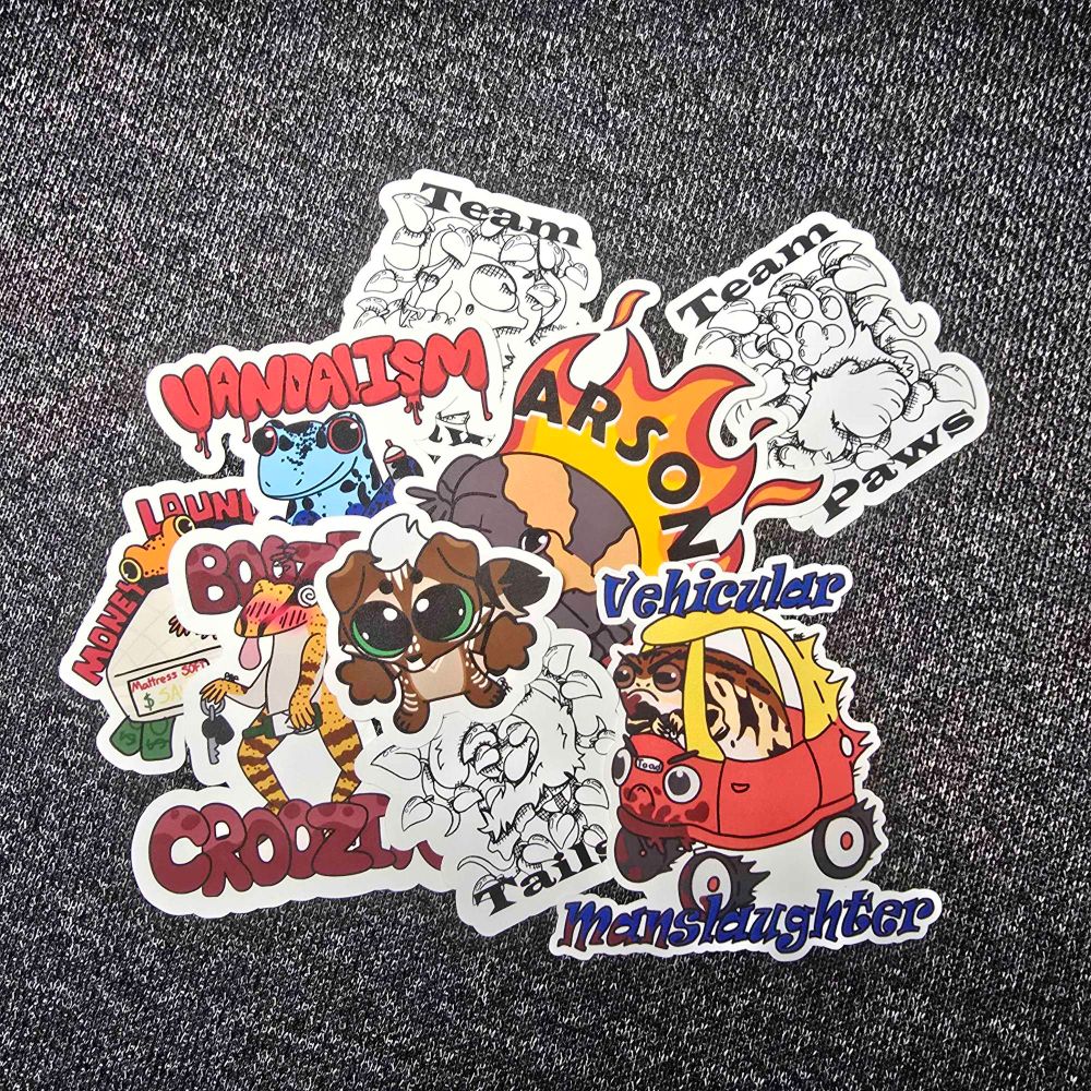 a pile of misc stickers, some of which including a skrunkle of my brown scottish fold cat sona, a drunk frog with car keys that says booze croozin, a frog driving anlittle tykes car thats bloodied that says 'vehicular manslaughter, a frog on fire that says arson, team maws, paws, ans tails, and more 