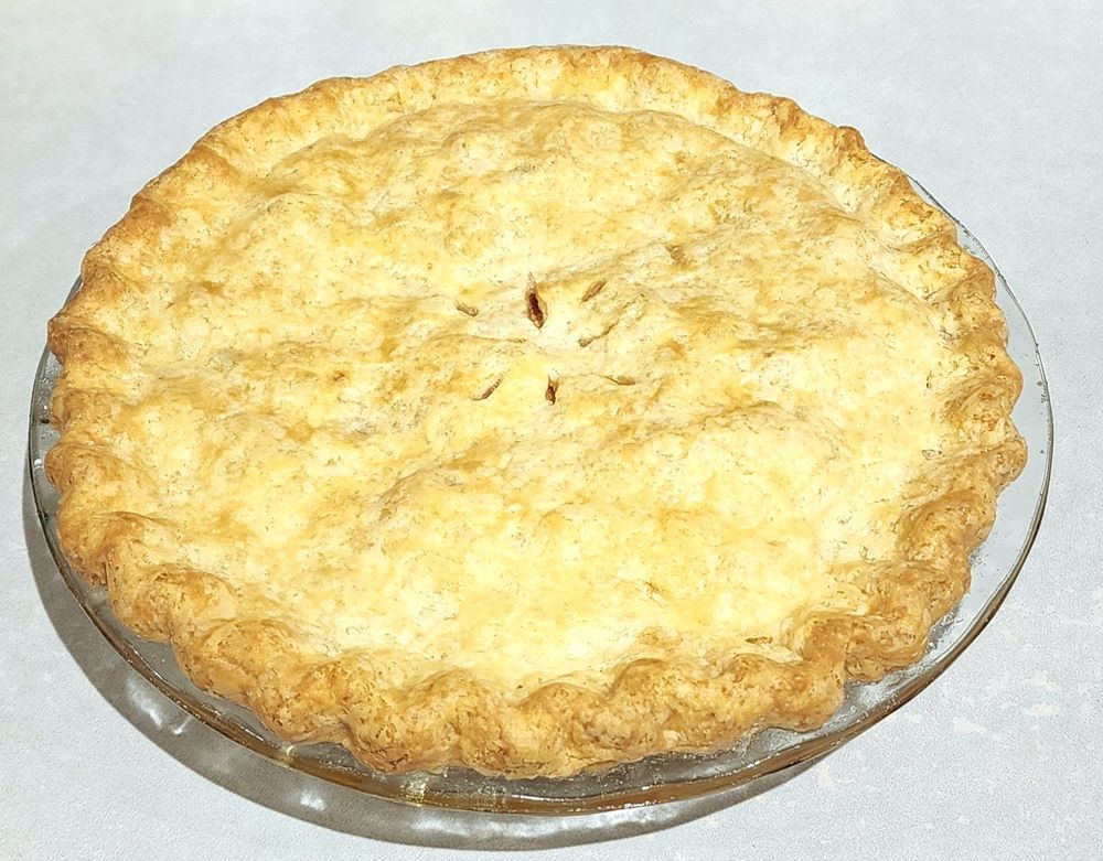 Golden brown double crust apple pie with fluted sdges.