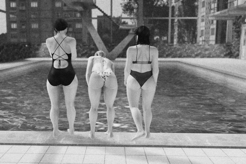 Three women in bathing suits stand hesitantly at the edge of a large public pool, their backs to the camera. One leans down. Black and white.