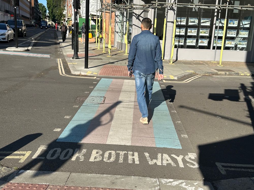 A pedestrian crossing in Camden painted in the colours of the Trans Flag