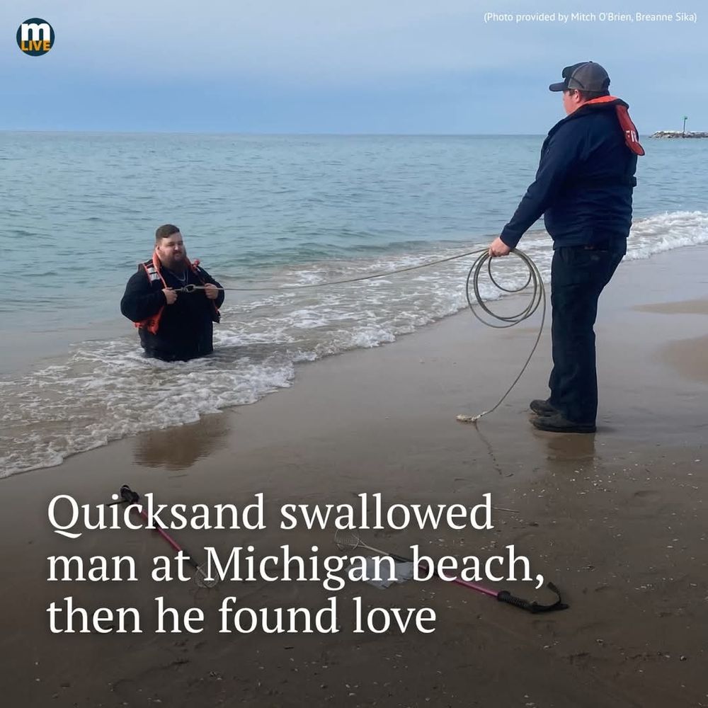 A picture of a man stick hip-deep in sand on the shore of a lake, with a person standing near him. The caption reads "quicksand swallowed man at Michigan beach, then he found love"
