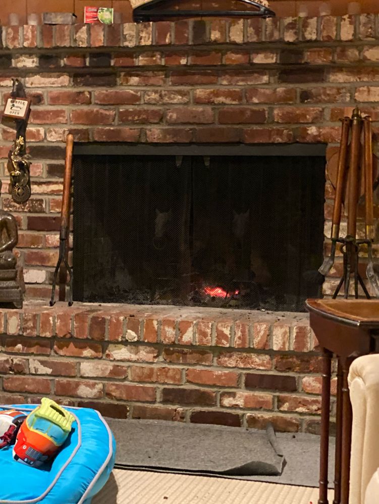 A brick fireplace with the last embers