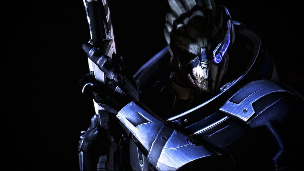 A screenshot from the video game Mass Effect 3 from the Legendary Edition.

The photo features Garrus Vakarian, an alien companion, standing tall in the darkness, holding his futuristic sniper rifle up in the air. His right eye is hidden by shadows, while his left is covered by his visor.