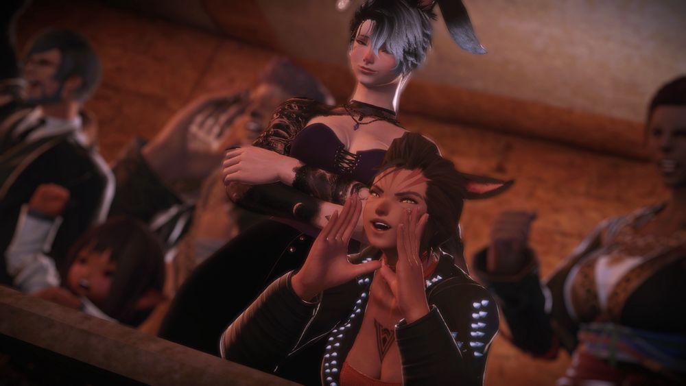 P’uuma Lanaa leans forward against the railing of a spectator’s box in the Bloodsands, hollering at the offscreen match alongside the rest of the visible, blurred crowd. Besides P’uuma, Ariana Paharo stands with crossed arms and a soft smile as her eyes focus not on the gladitorial combat, but instead on the Miqo’te woman she came with.