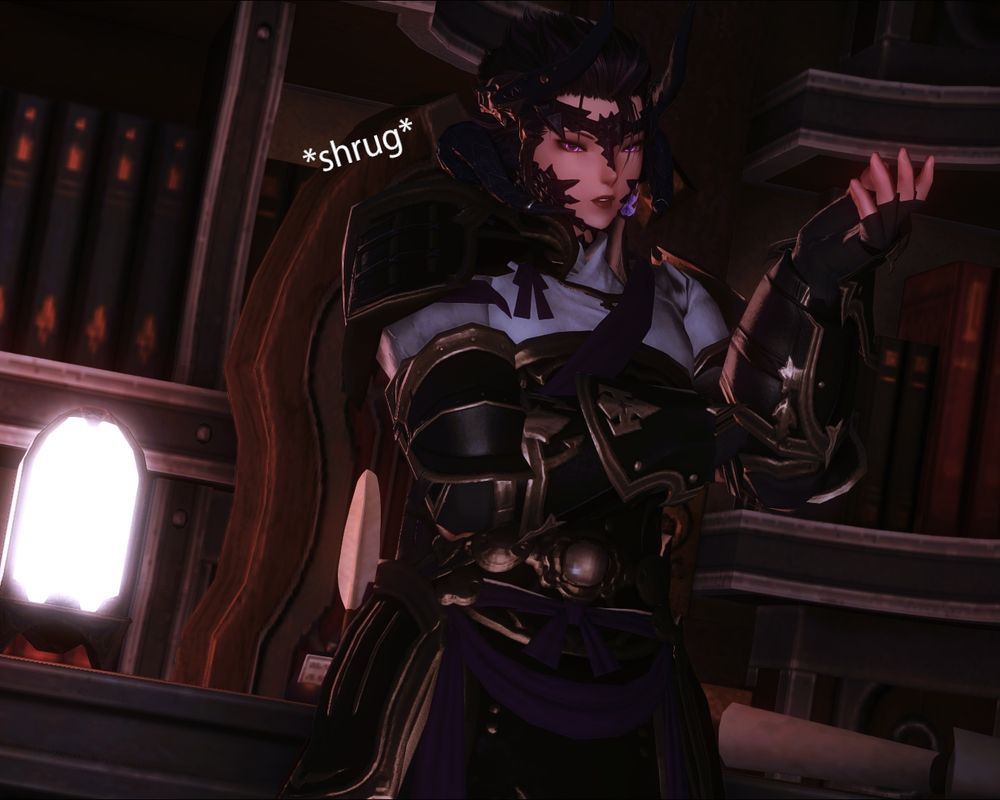 Zaya Yuuno-Dalamiq leans against her home desk, shrugging at the camera with a confused, if subtle, expression.