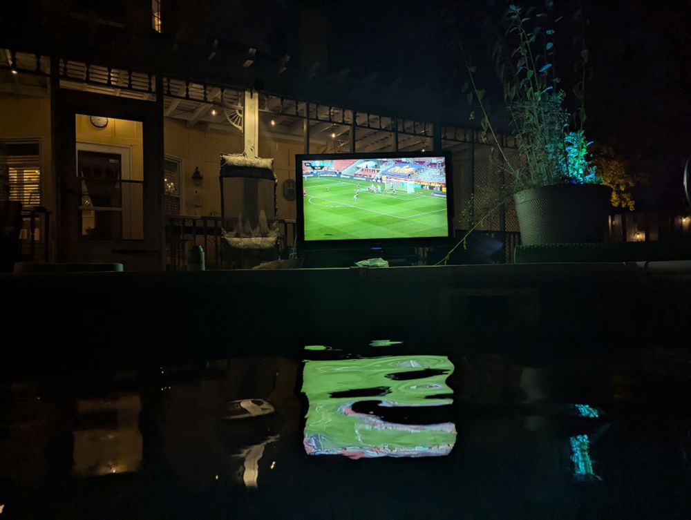 KC current game on a TV by the pool