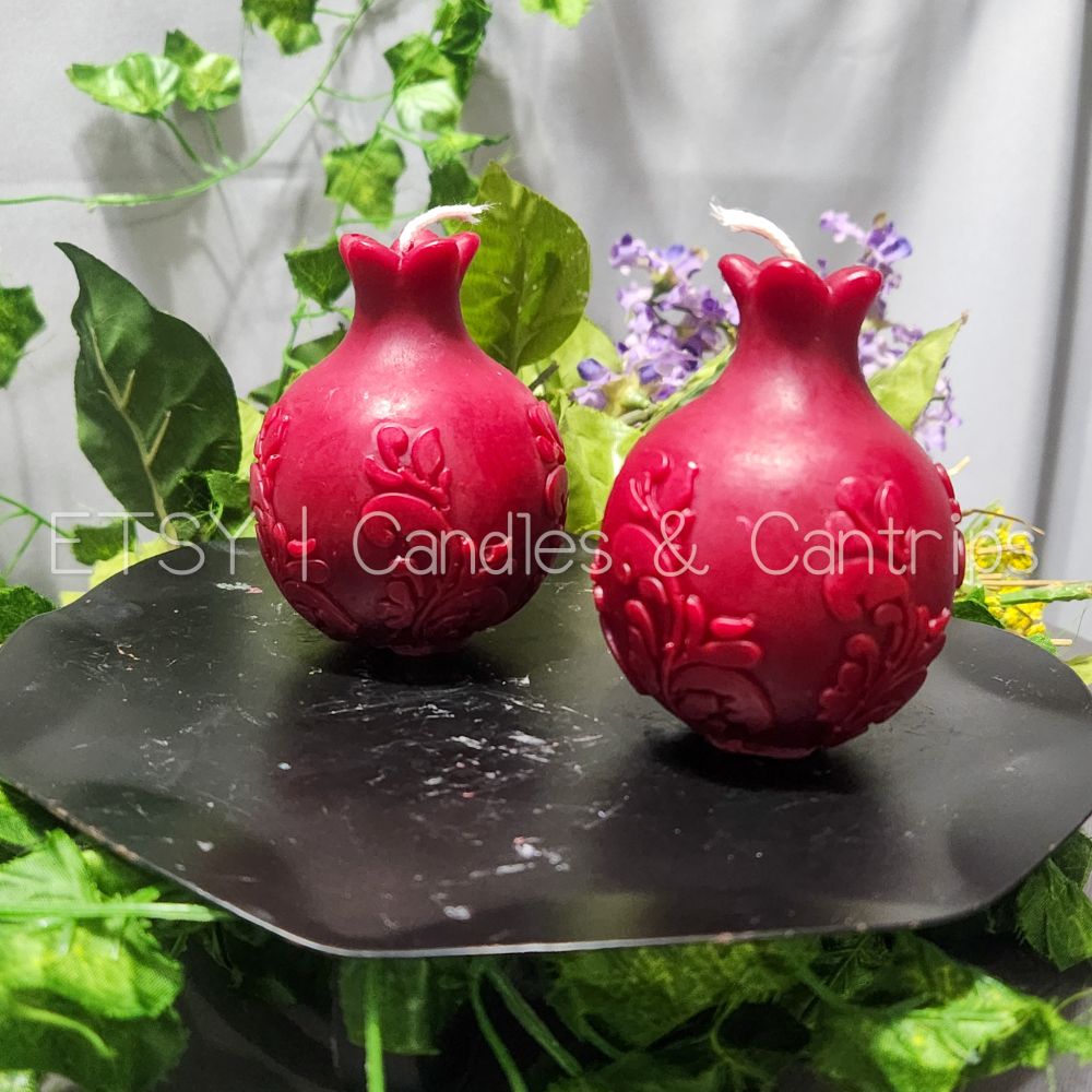 A display of red candles shaped like pomegranates.