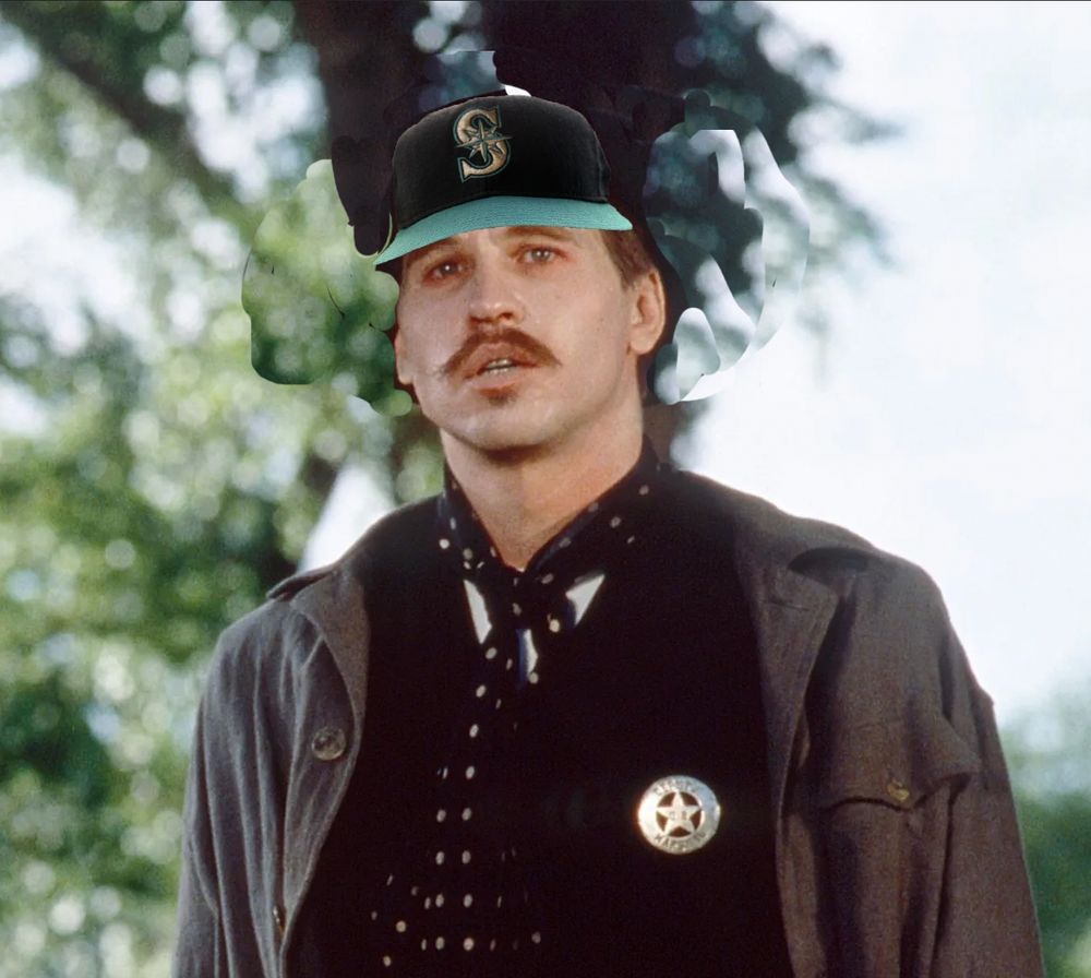 Val Kilmer as Doc Holliday in Tombstone but with a shiftily photoshopped Mariners cap