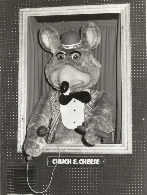 the original Chuck E. Cheese, complete with mobster tuxedo, bowler hat, and cigar