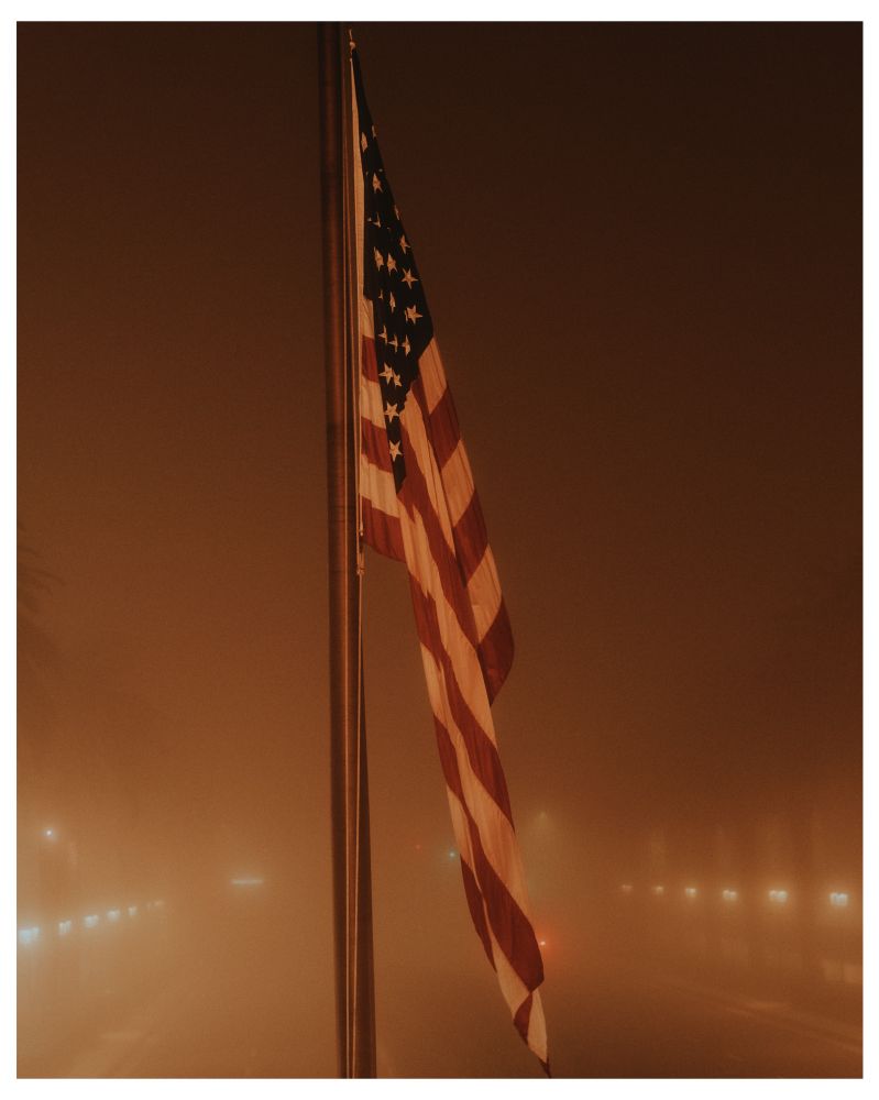 The United States Flag framed by receding lights in fog