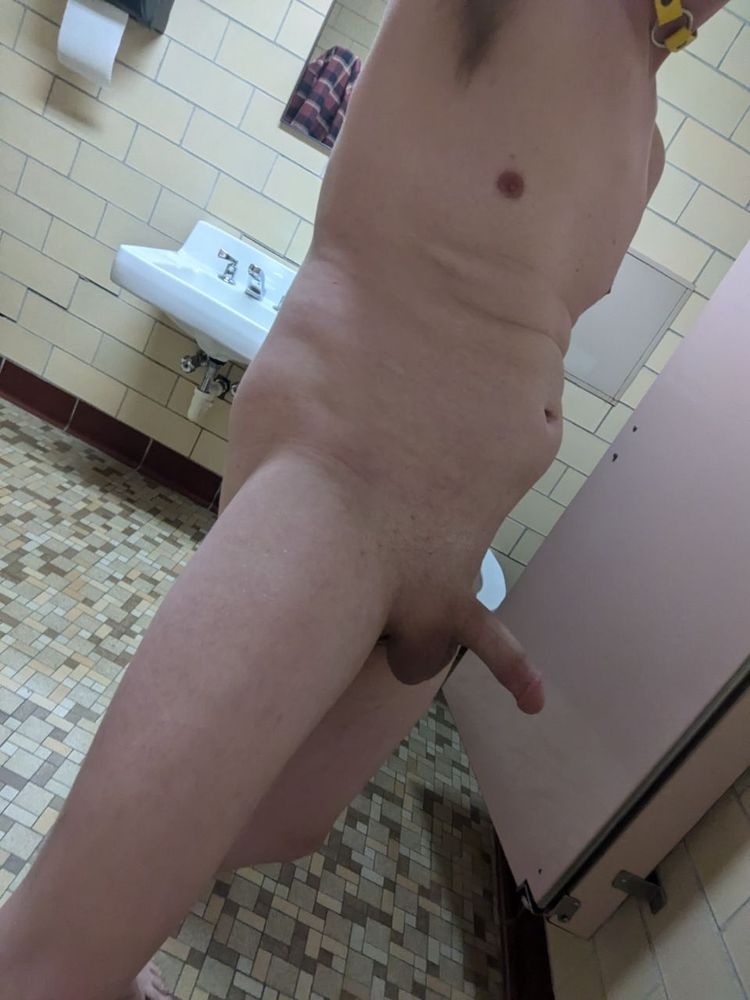 Naked and hard in front of a sink and open stall door
