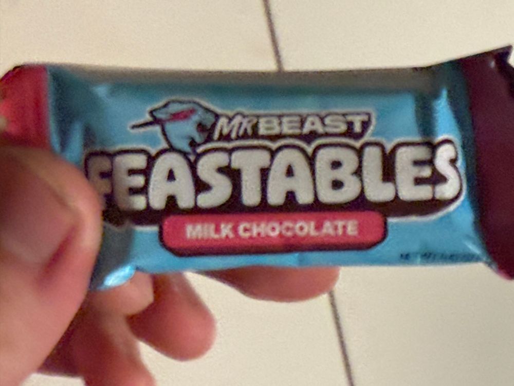 Holding a MrBeast’s Feastables chocolate in my hand