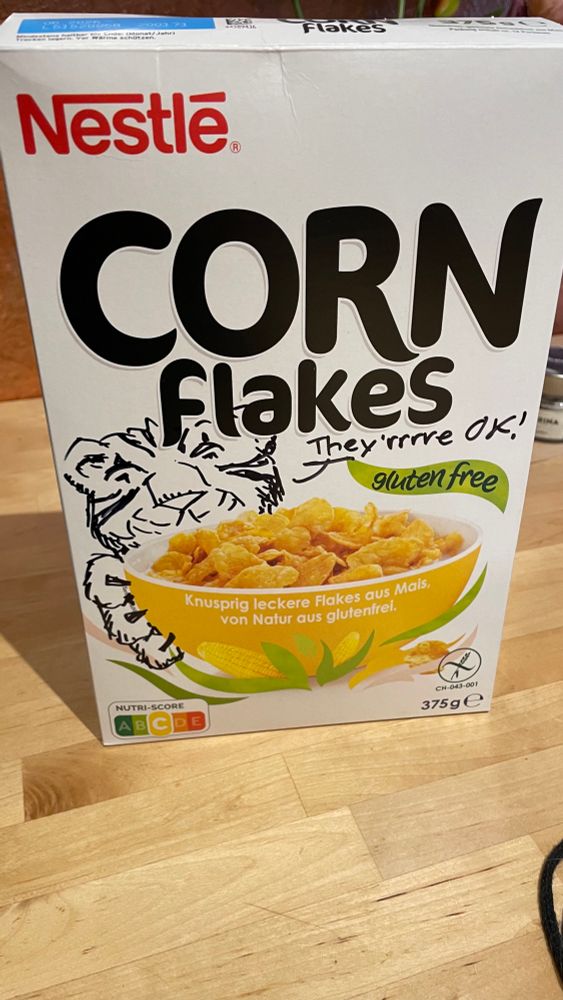 A generic-looking corn flakes. I drew onto it the face of a tiger saying “They’rrrre OK!”