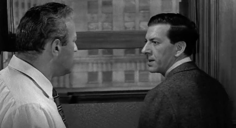 A still from 12 Angry Men (1957). Two men argue. 
