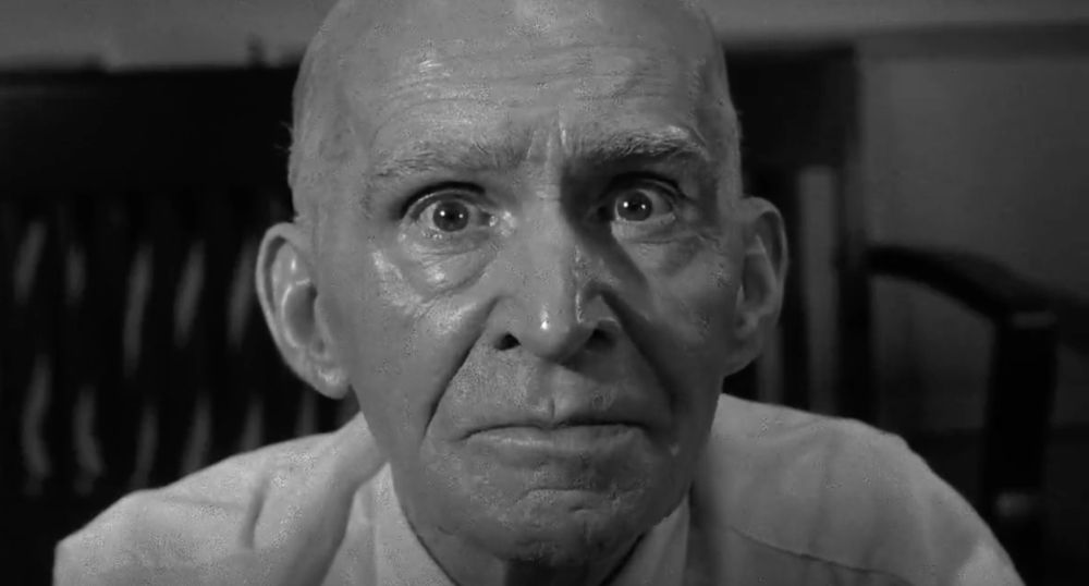A still from 12 Angry Men (1957). A close-up shot of an old man's sweaty face. 