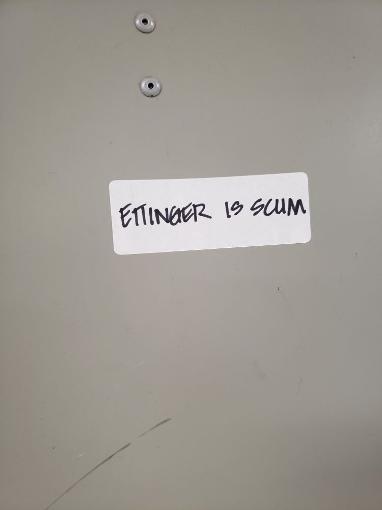 Graffiti art on a locker criticizing the CEO of Canada Post Corp