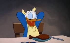 Donald Duck preparing to eat a chicken drumstick. Bird eating bird. This is the reality of our cruel world.