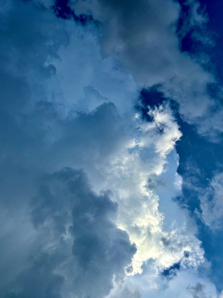 storm clouds rolling in, electrifying the sky with a blue charge 
