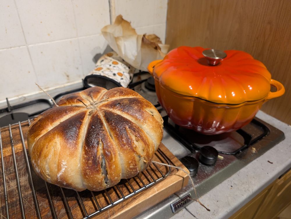 Pumpkin shaped bread baked inside a pumpkin shaped cat iron dish