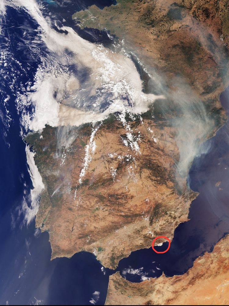 A satellite image of Spain, with a red circle highlighting the white-colored Almería region.