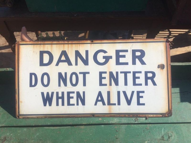 An old sign that says "Danger, do not enter when alive."