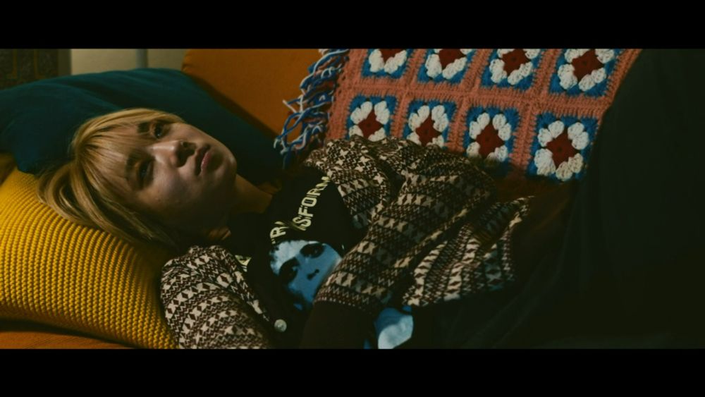 mahiro lies on her couch 