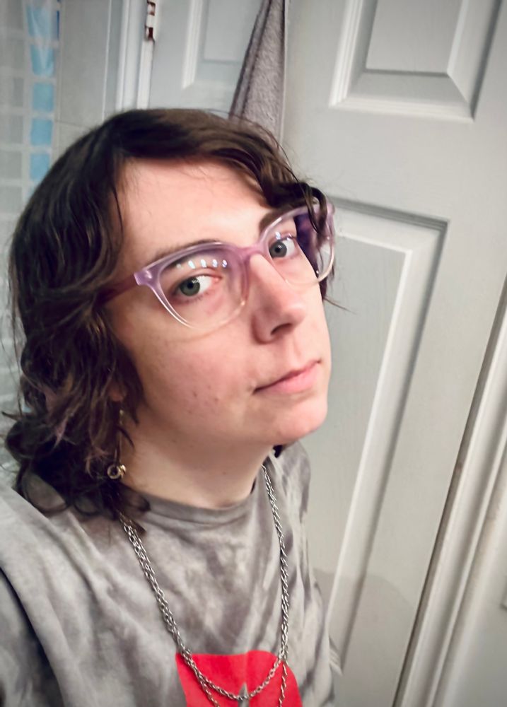 selfie. im wearing chains, dangly earrings, glasses. 