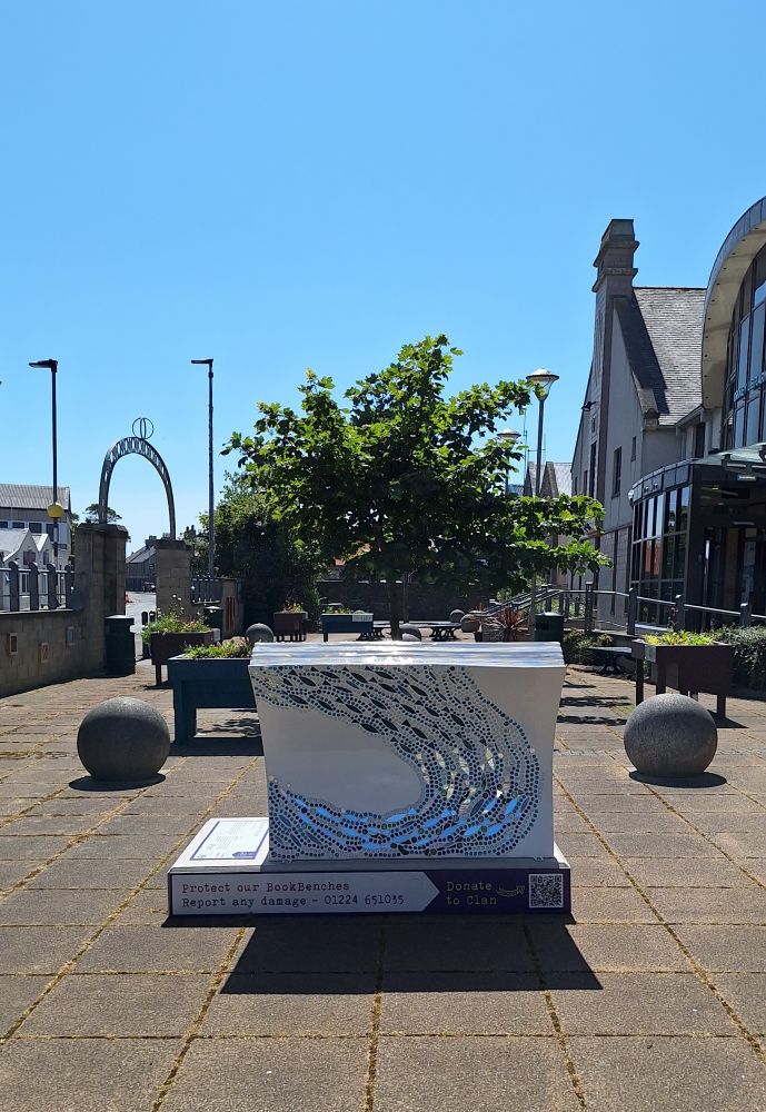 Out the front of Orkney Library & Archive on a sunny day. The book bench is in the foreground.