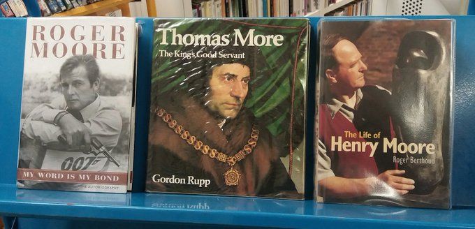 A shelf of 3 books about Roger Moore, Thomas More, and Henry Moore
