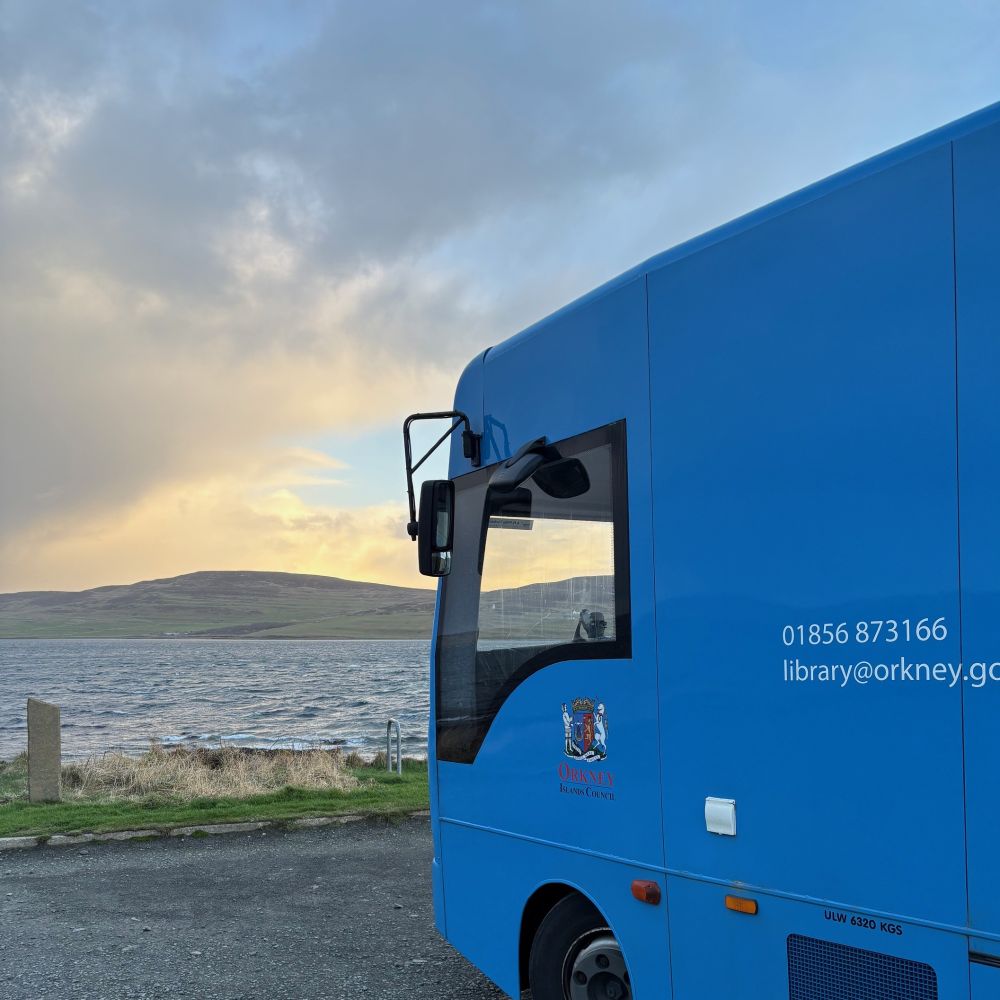 BookyMcBookface our Mobile Library parked up beside the sea
