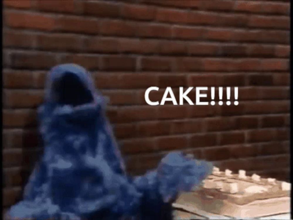 cookie monster is standing in front of a cake and says cake