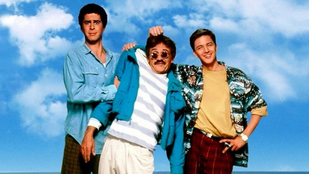 The hero image from the movie Weekend at Bernie's. Two young white men are holding up an older white man to make it look like he's not dead.