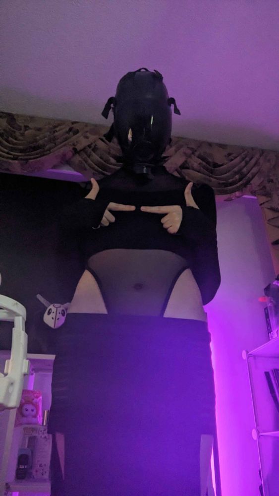 A shy figure dressed in all black clothing is doing the stereotypical subby action of pointing its fingers together and looking at the camera pleadingly. They've dawned the drone mask, but its yet unclear if they've been properly assimilated into the Hive yet.

They're wearing a black bodysuit with mesh accents on its stomach, gauntlets, and a parted skirt.