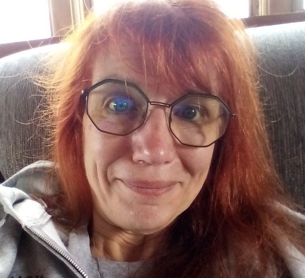 Smiling woman who just voted for Kamala and felt slightly hopeful that things might work out.